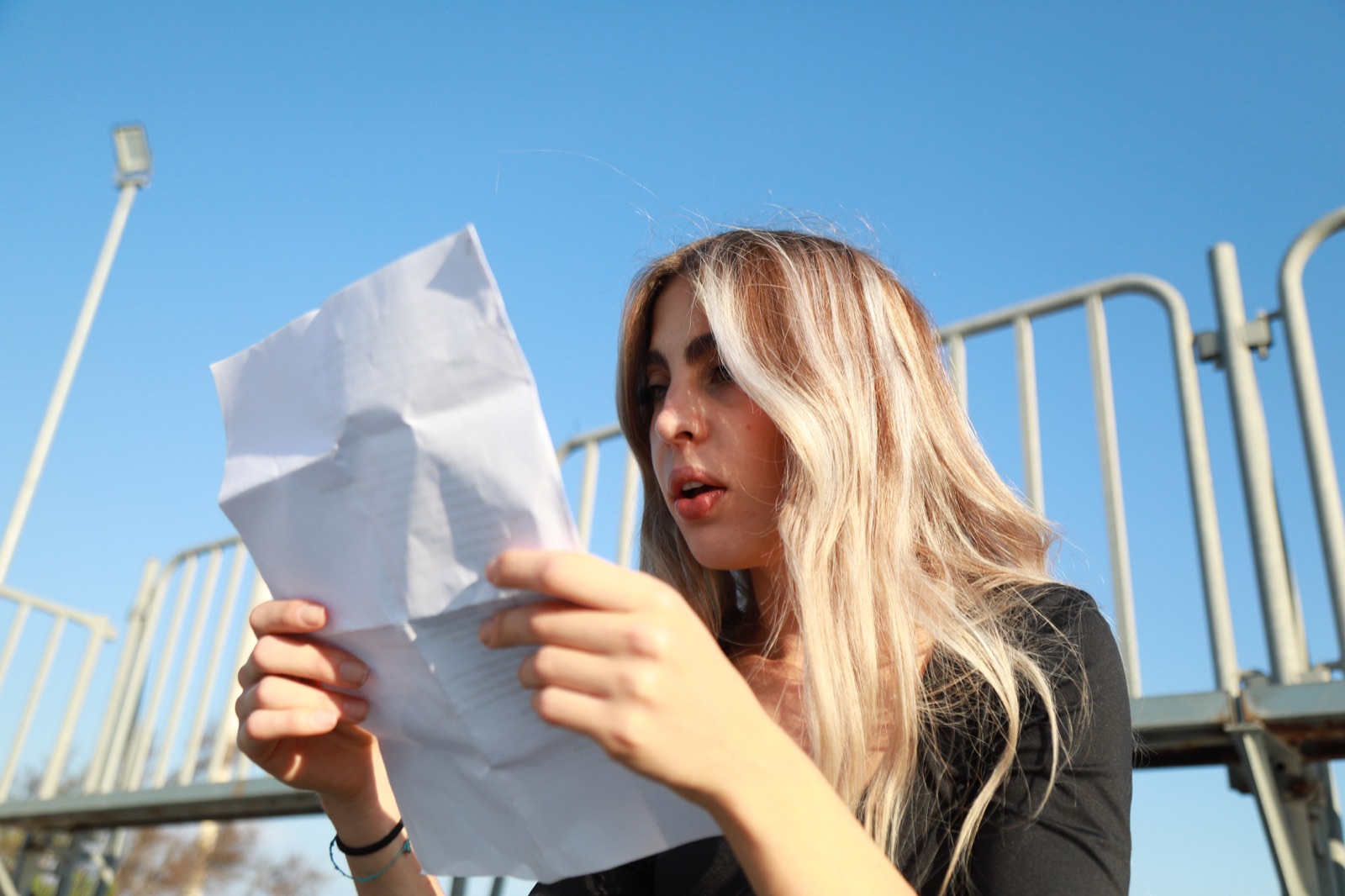 Woman carefully reading a collection letter she received about an old debt