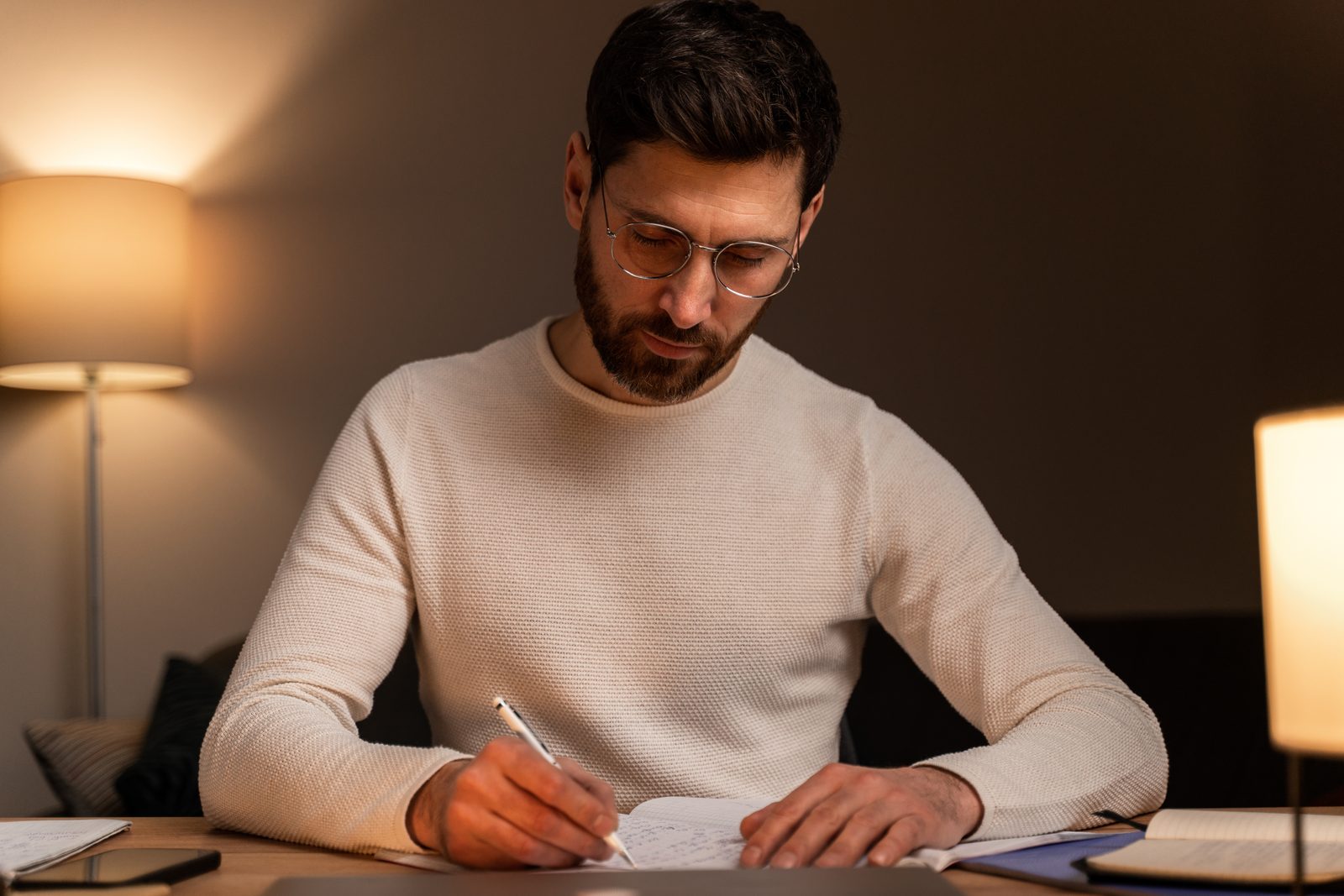 Man writing a pay for delete letter at a desk at home